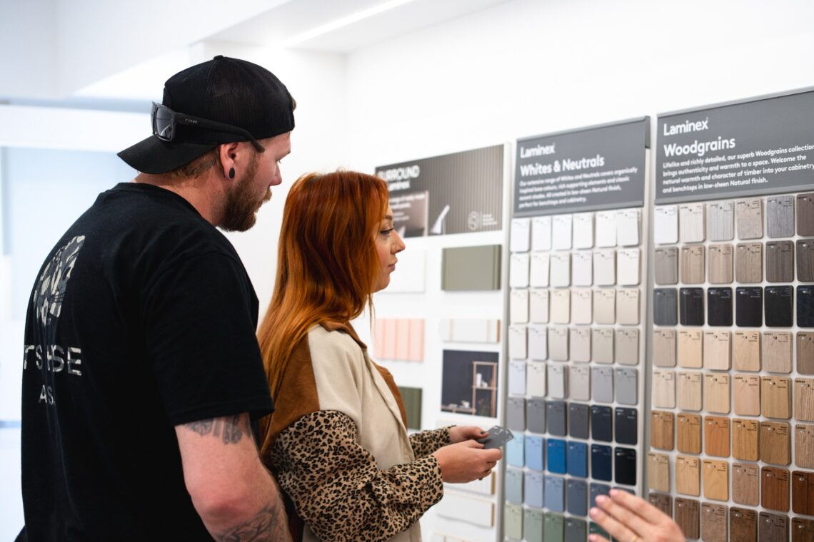 Two people browsing colour selections for their new home