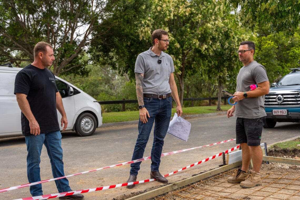 Three Avia Homes staff members discussing land quality