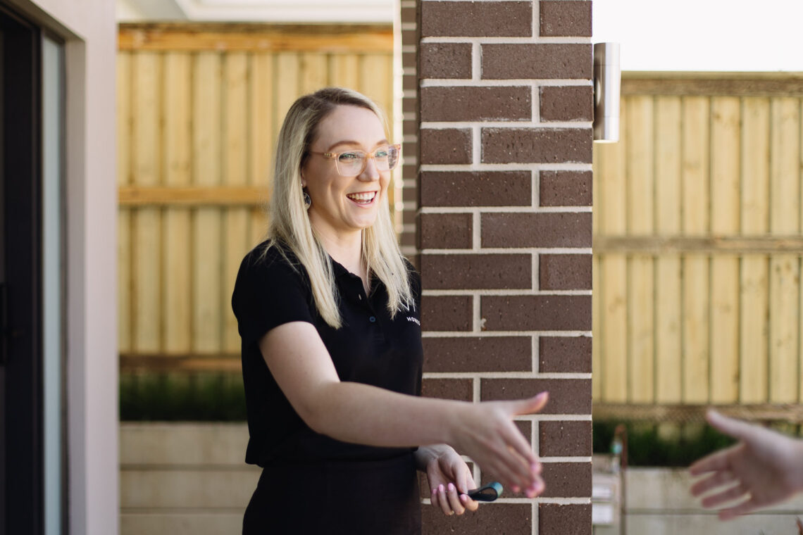 Avia Homes staff member greeting and shaking hands with a client