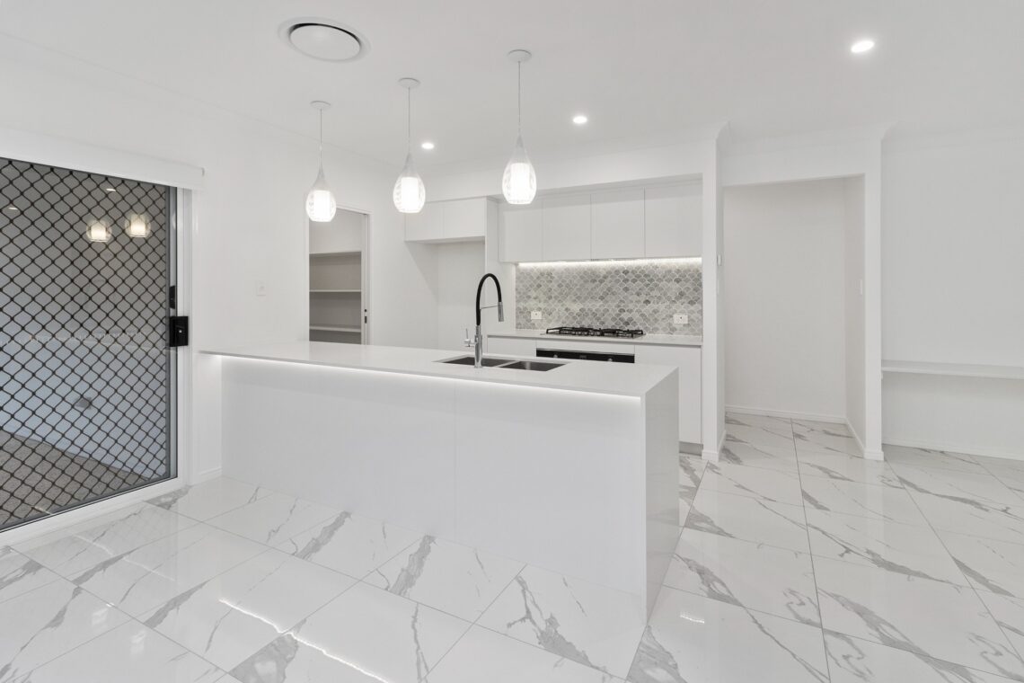 A bright, well-lit modern kitchen with premium finishes
