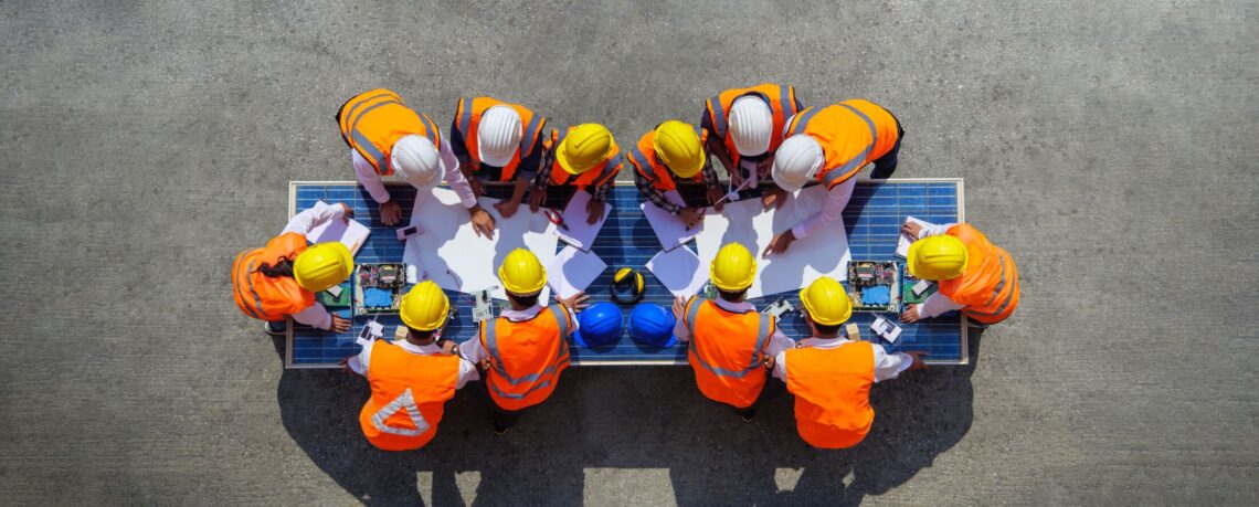 Construction workers looking at building plans on-site